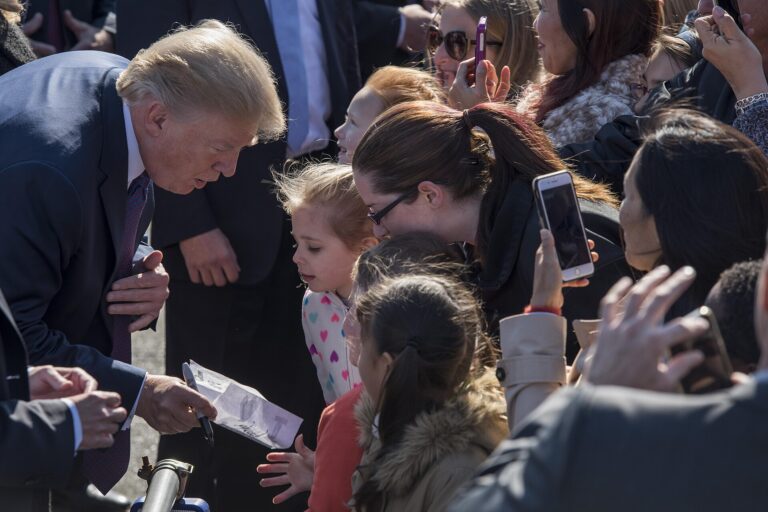 President Donald J. Trump signs a note from a young audience member, Nov. 5, 2017, at Yokota Air Base, Japan. Trump greeted service member’s families and thanked them for their sac